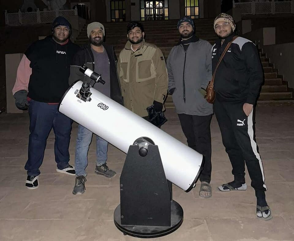 Guest using a telescope during a Jaisalmer stargazing tour